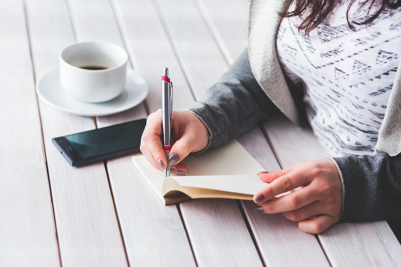 Woman, write, notepad — THCA Flower: Unveiling Its Potential in Medical Cannabis