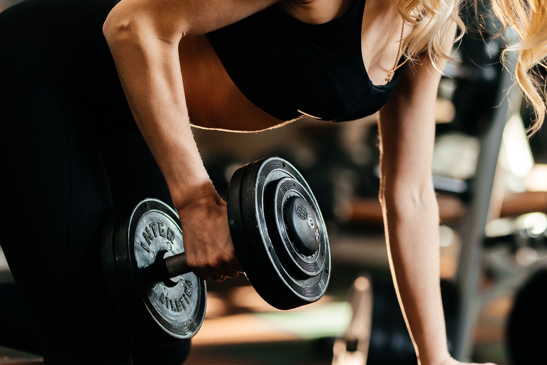 Focused woman lifting a dumbbell, highlighting strength and fitness goals. — "Top Sources to Buy Trenbolone Enanthate Online"